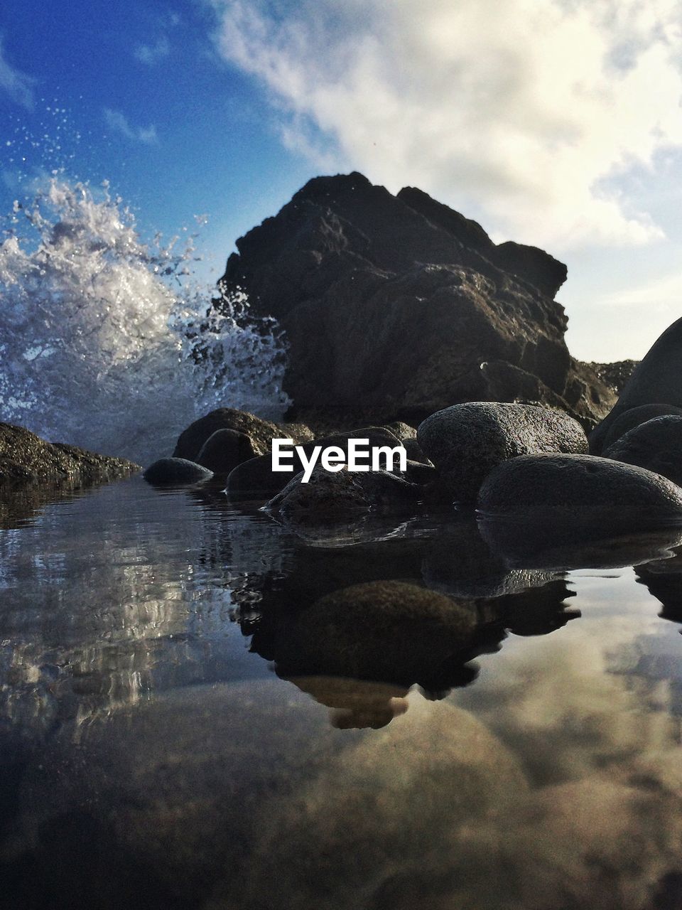 View of waves breaking rocks