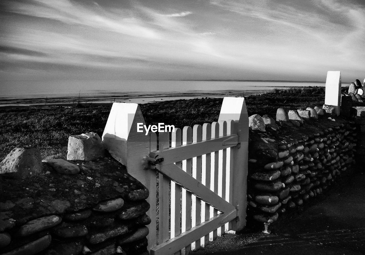 Scenic view of sea against sky with gate