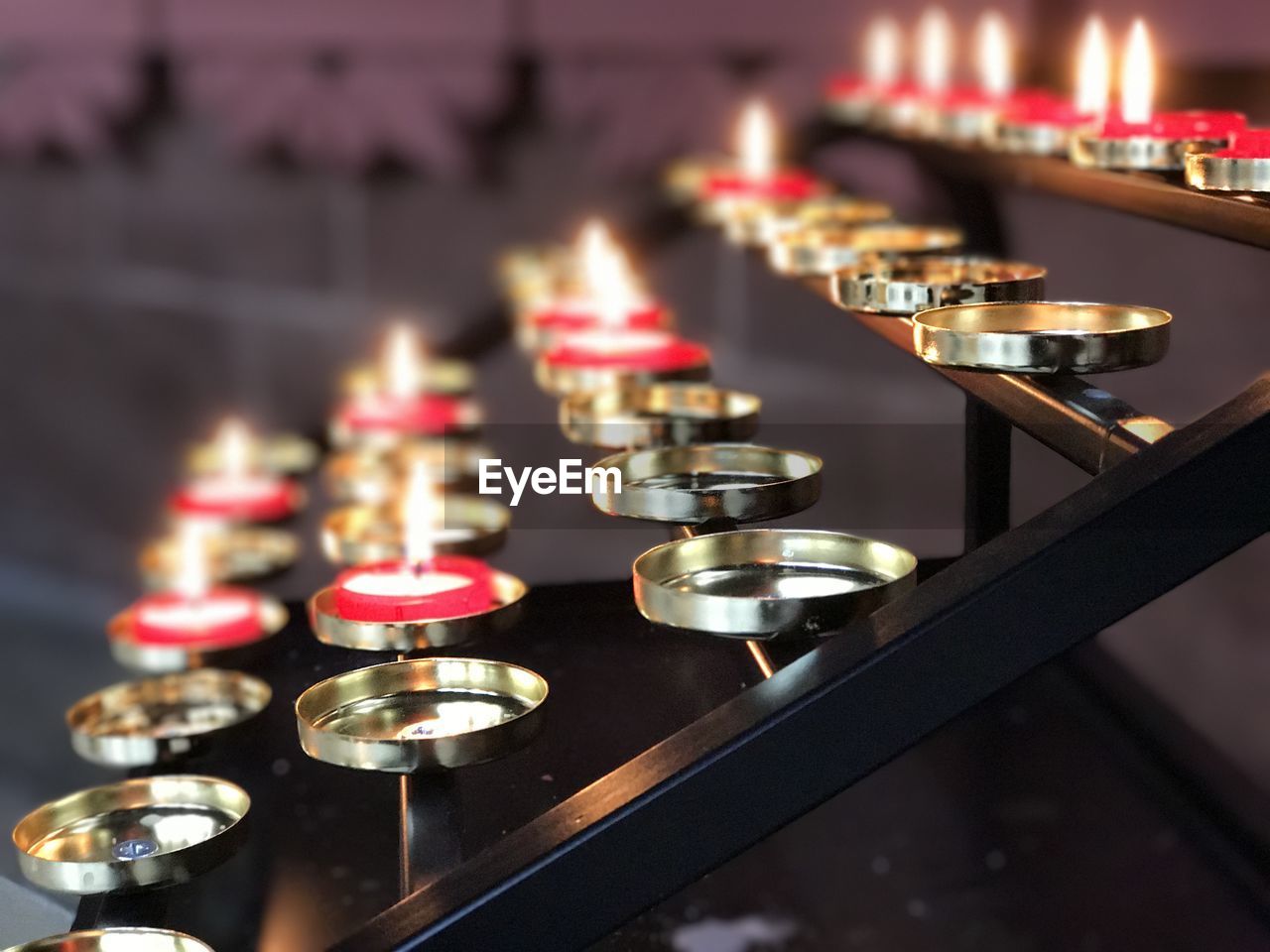 Close-up of illuminated candles on table