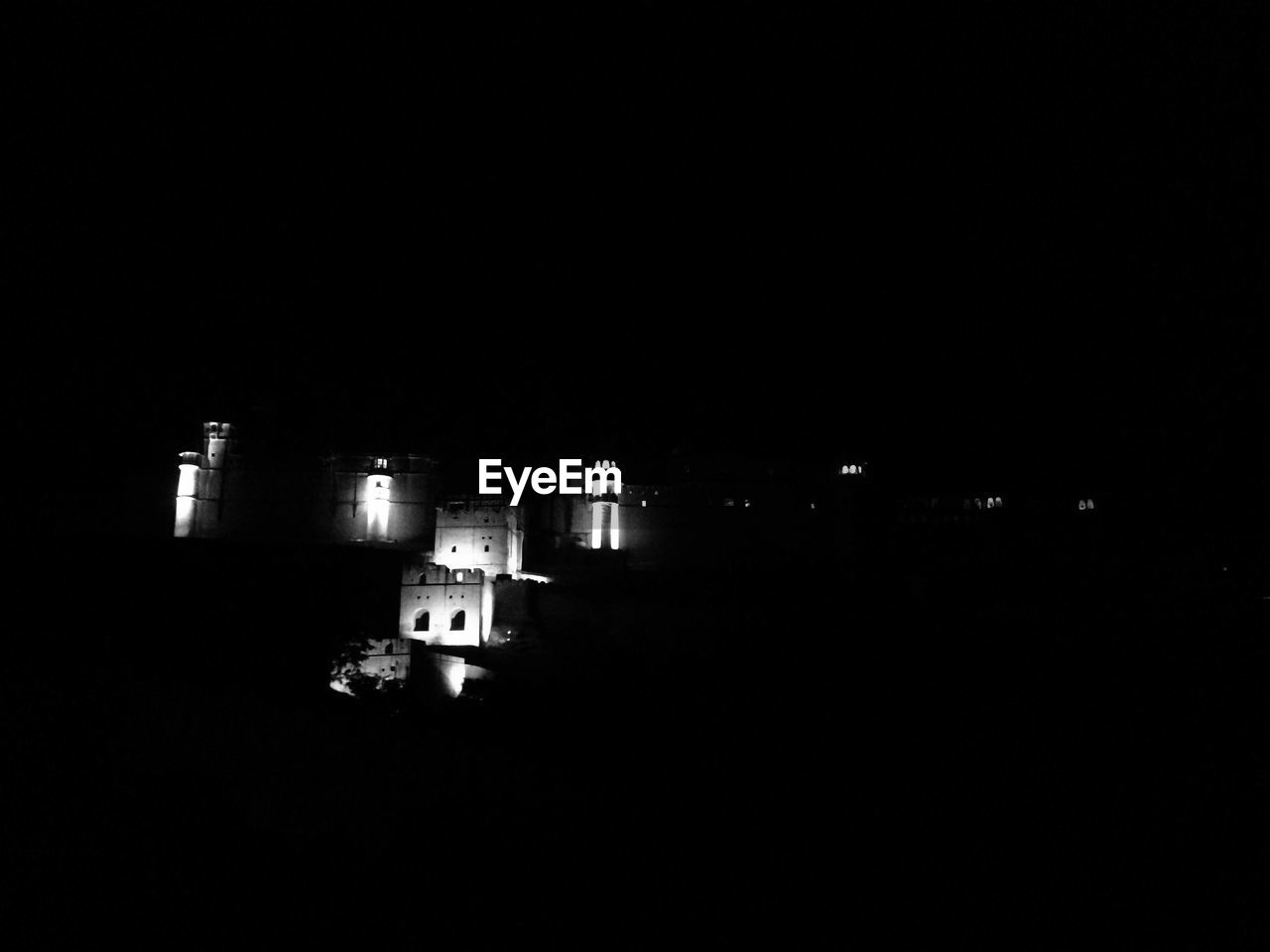 ILLUMINATED BUILDING AGAINST SKY AT NIGHT