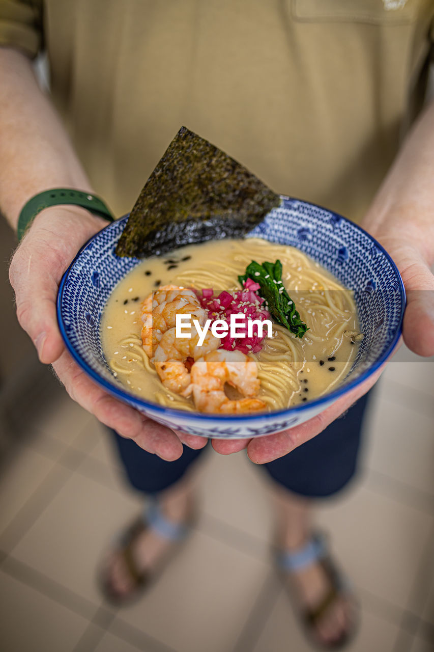 cropped hand of woman holding food