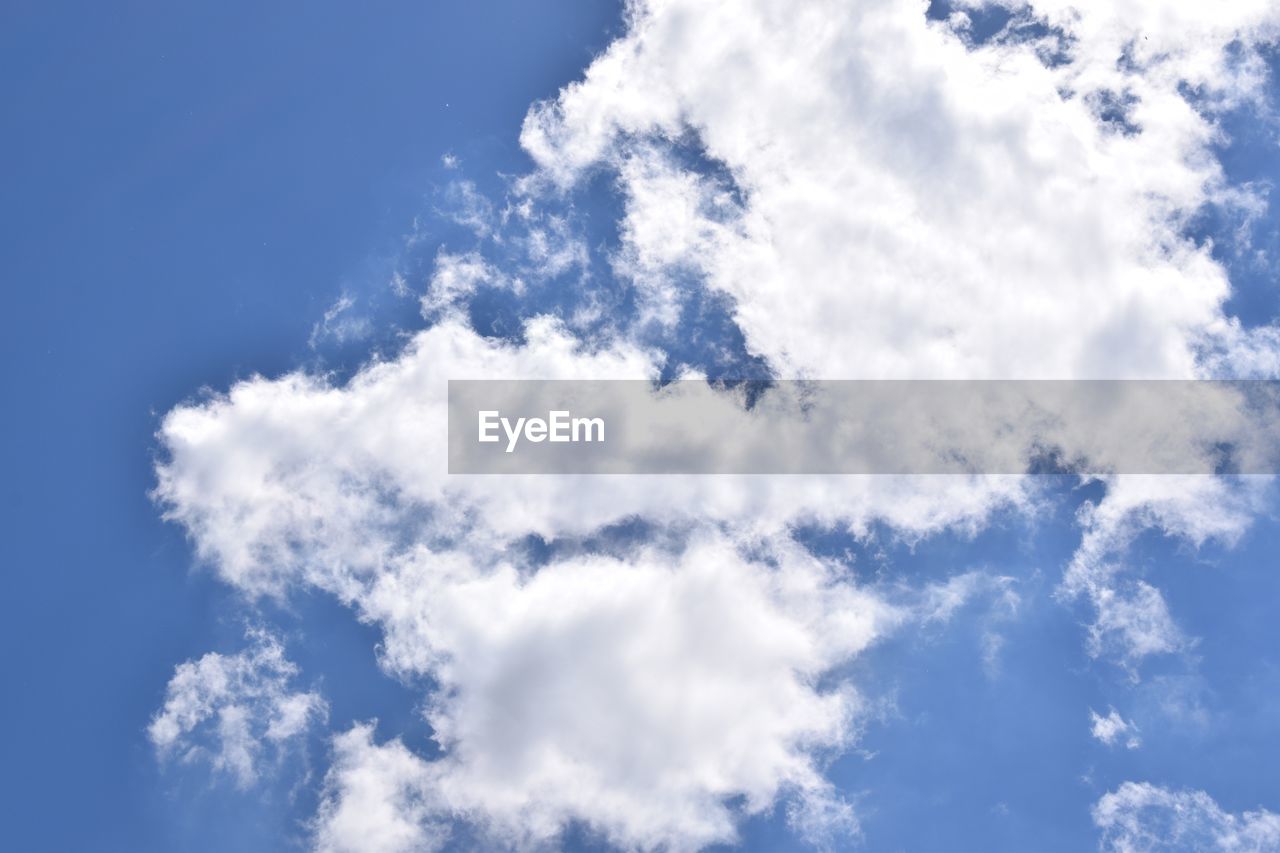 LOW ANGLE VIEW OF WHITE CLOUDS IN BLUE SKY