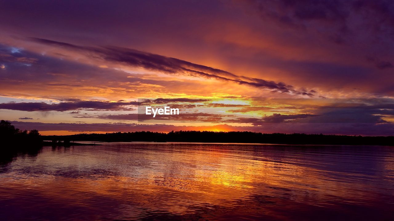 SCENIC VIEW OF LAKE AGAINST ORANGE SKY