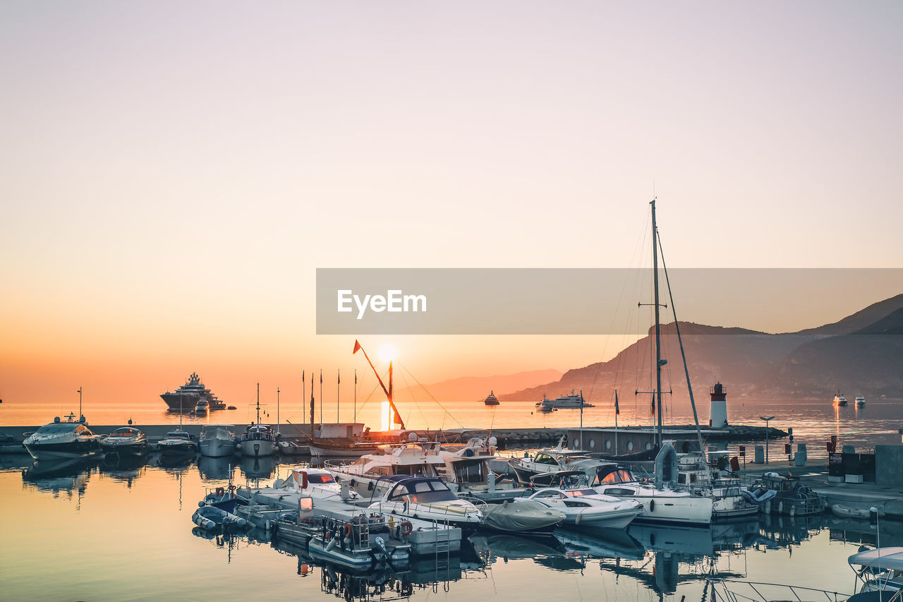 Boats in marina at sunset