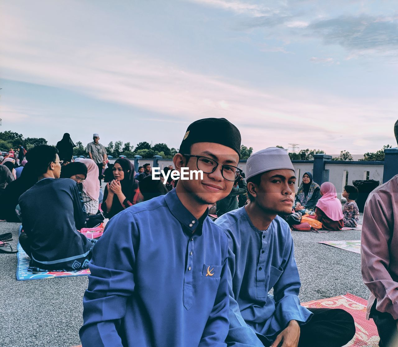 GROUP OF PEOPLE SITTING AGAINST THE SKY