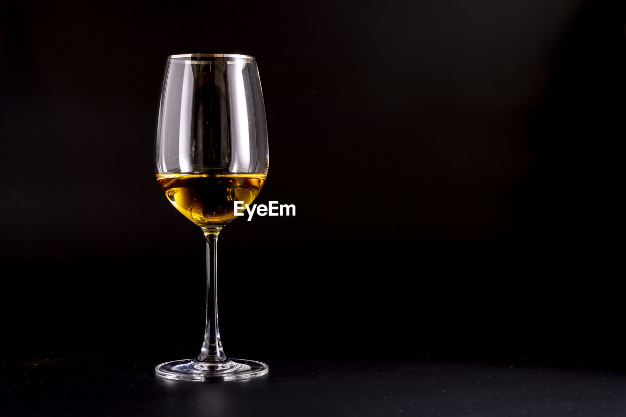 close-up of wineglass against black background