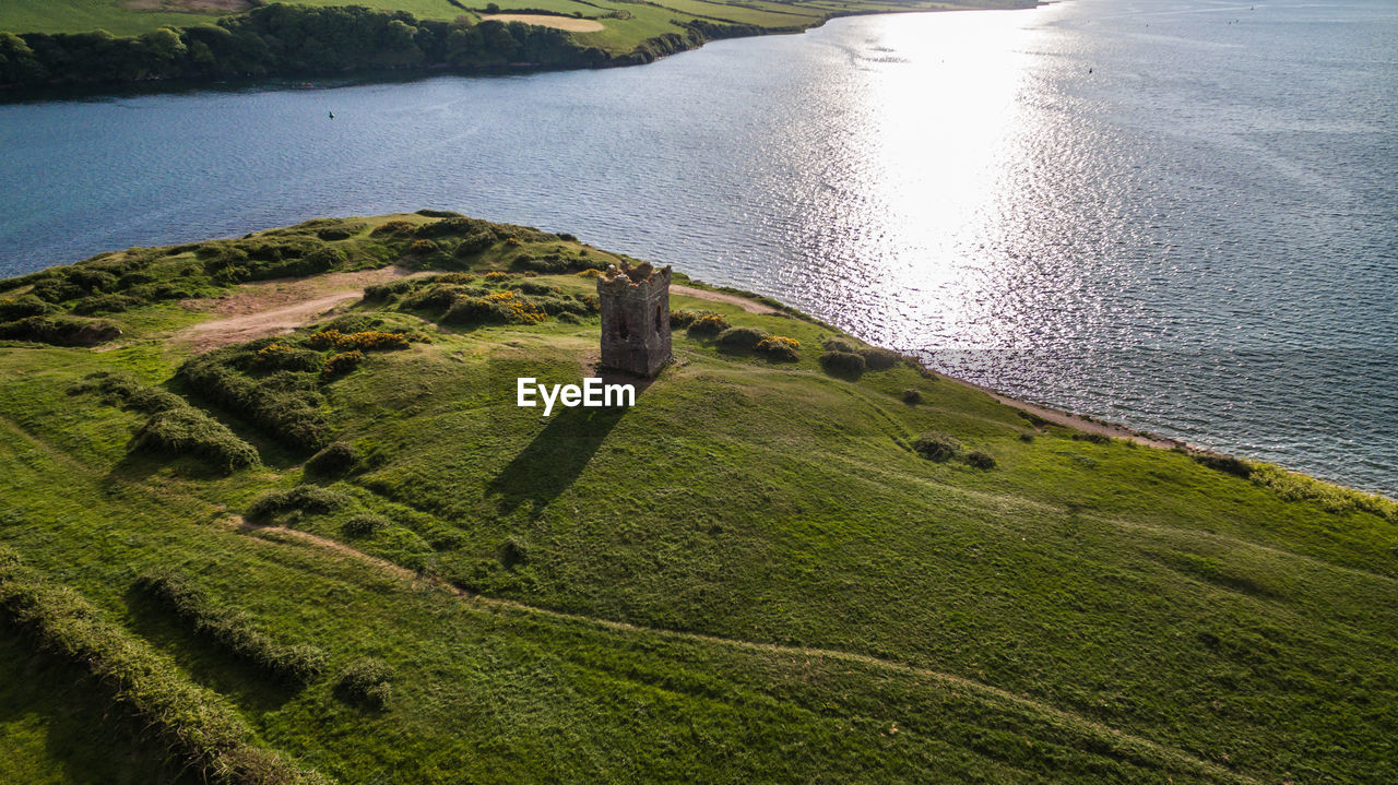 High angle view of field by river on sunny day