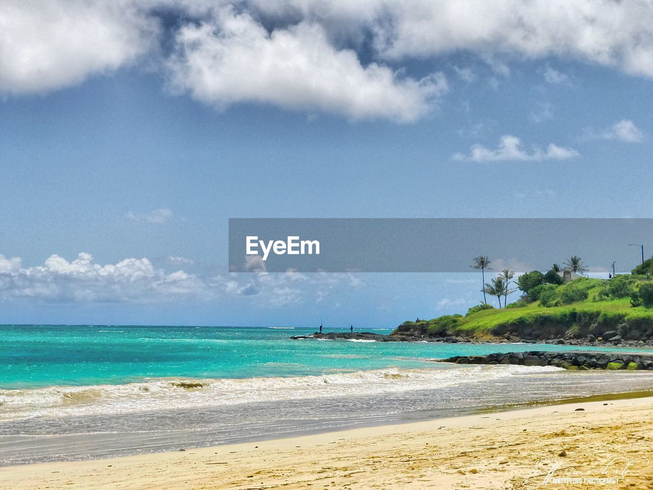 View of beach against cloudy sky