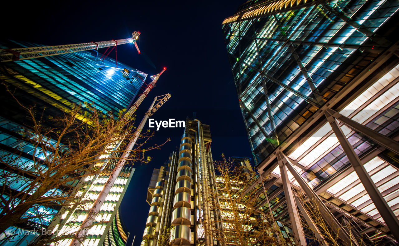 LOW ANGLE VIEW OF ILLUMINATED BUILDINGS AGAINST SKY