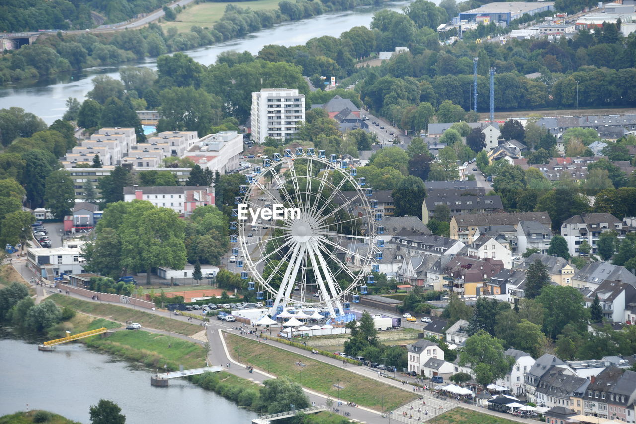 HIGH ANGLE VIEW OF FERRIS WHEEL BY BUILDINGS IN CITY