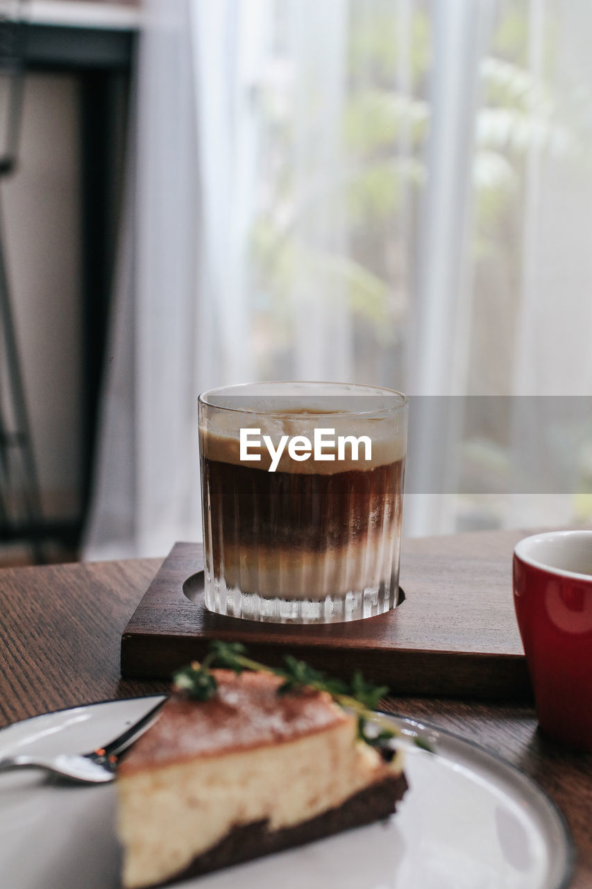 CLOSE-UP OF COFFEE CUP ON TABLE AT HOME