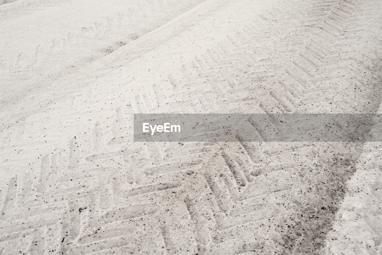 High angle view of footprints on sand