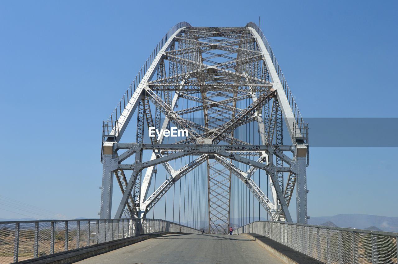 Metal bridge against clear blue sky