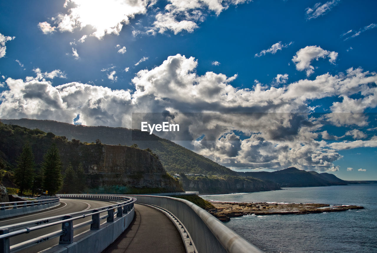 Panoramic view of road by sea against sky