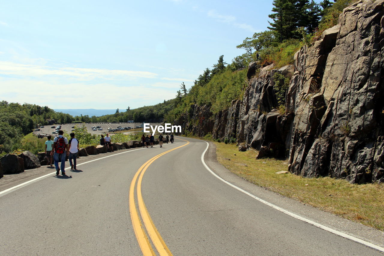 PEOPLE RIDING MOTORCYCLE ON ROAD