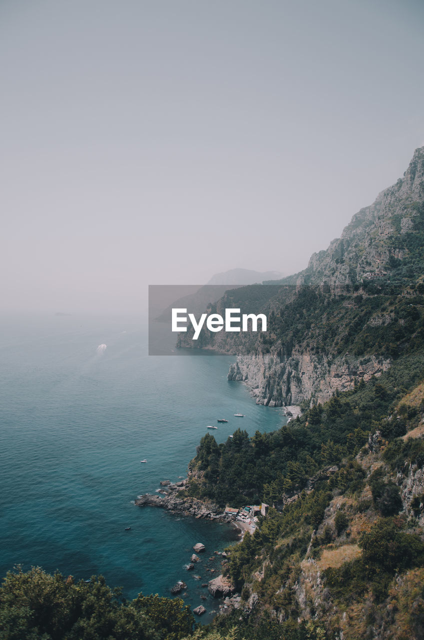 High angle view of sea and mountains against sky