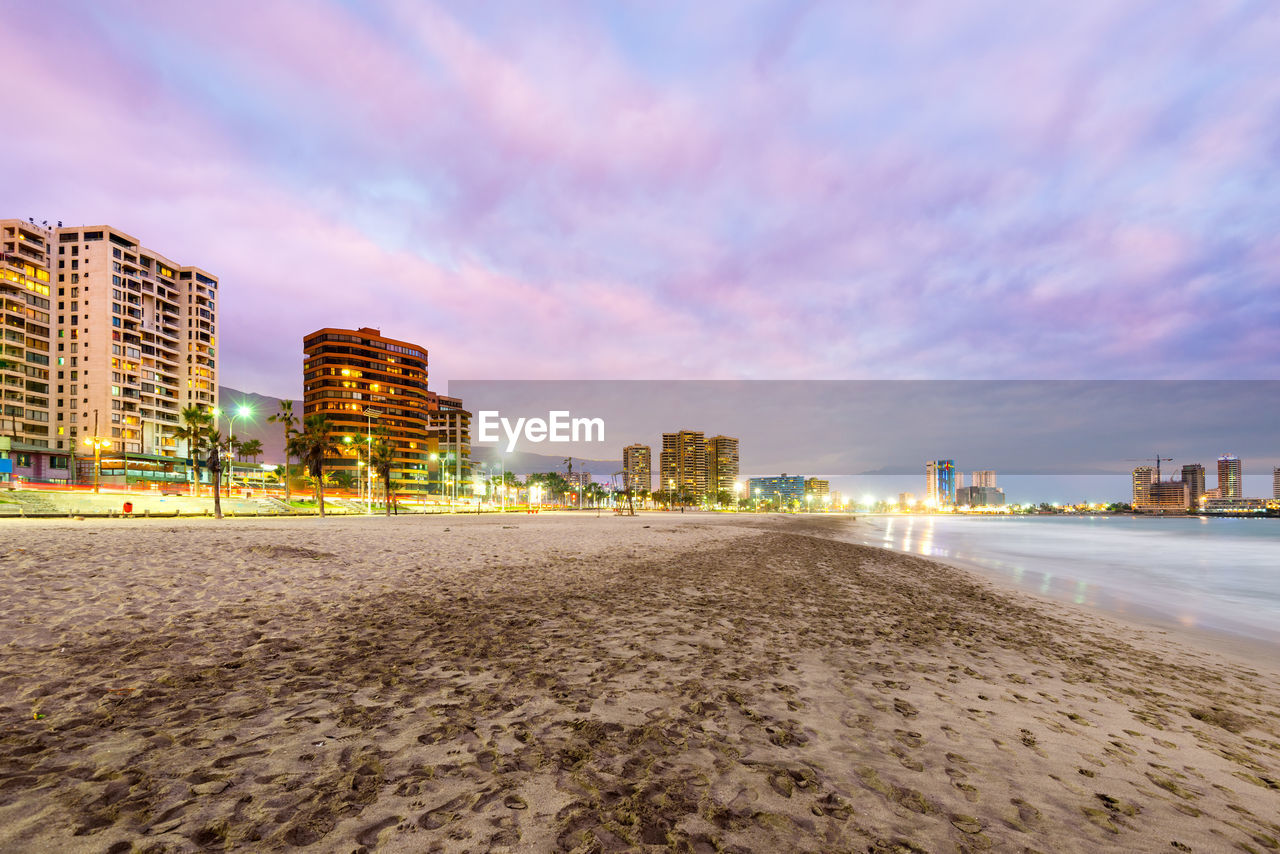 VIEW OF BEACH AND BUILDINGS AGAINST SKY