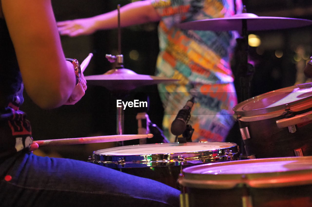 Cropped hand of man playing drum