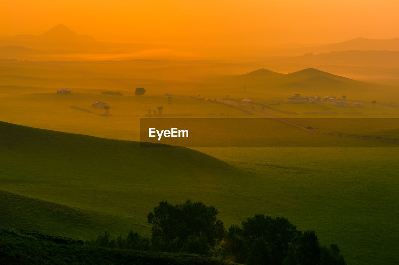 Scenic view of mountains against sky at sunset