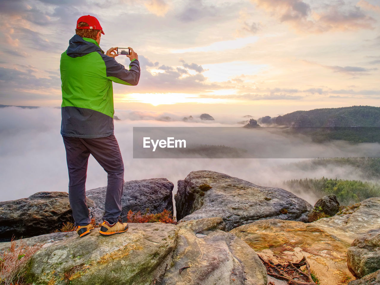 Hiker travel alone, take and share photos from outdoor trips. fall nature within misty morning. 