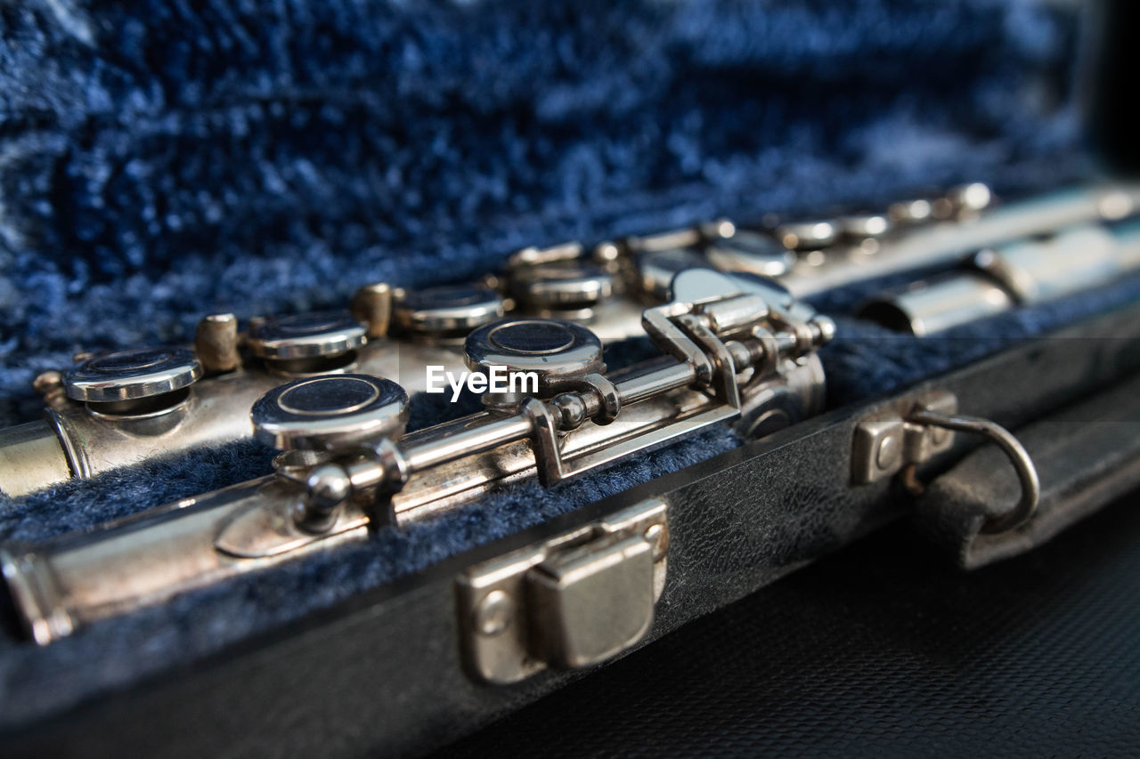 Close-up of musical instrument in blue container