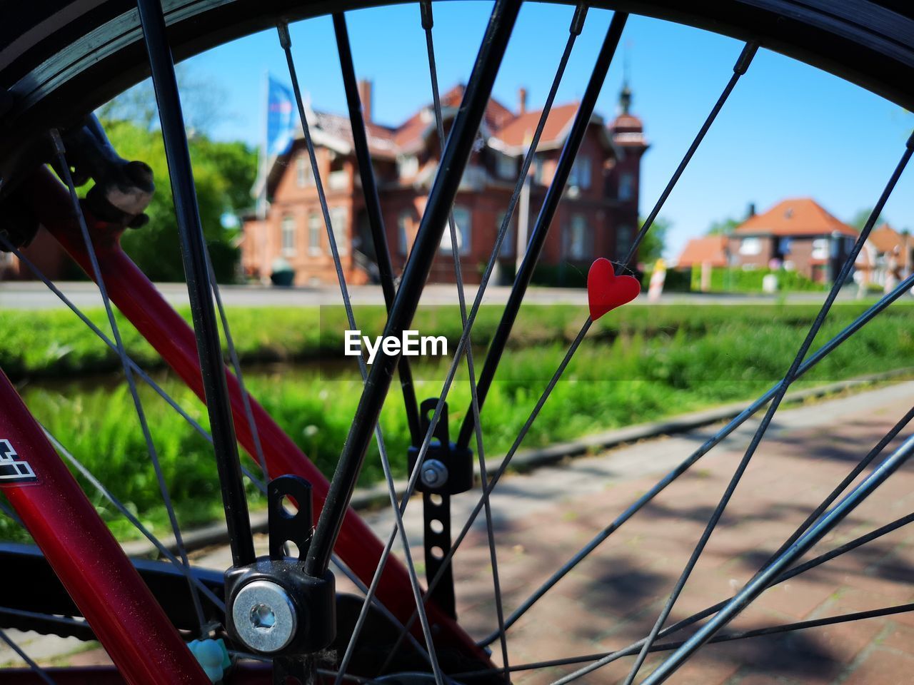 CLOSE-UP OF BICYCLE WHEEL ON FIELD