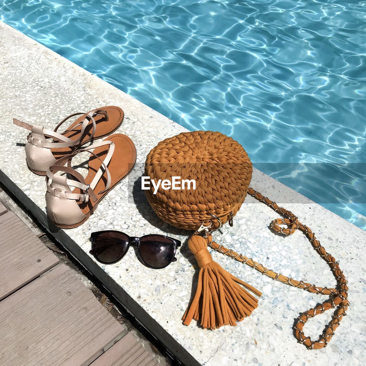 High angle view of personal accessories at swimming pool