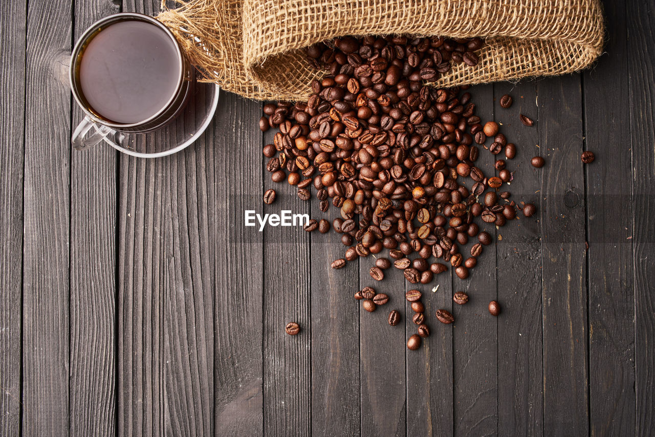 food and drink, food, coffee, wood, roasted coffee bean, freshness, brown, drink, table, healthy eating, wellbeing, no people, seed, rustic, still life, directly above, refreshment, indoors, studio shot, ingredient, spice, cup, large group of objects, burlap, high angle view, copy space, mug, produce, hot drink, scented, coffee cup, abundance