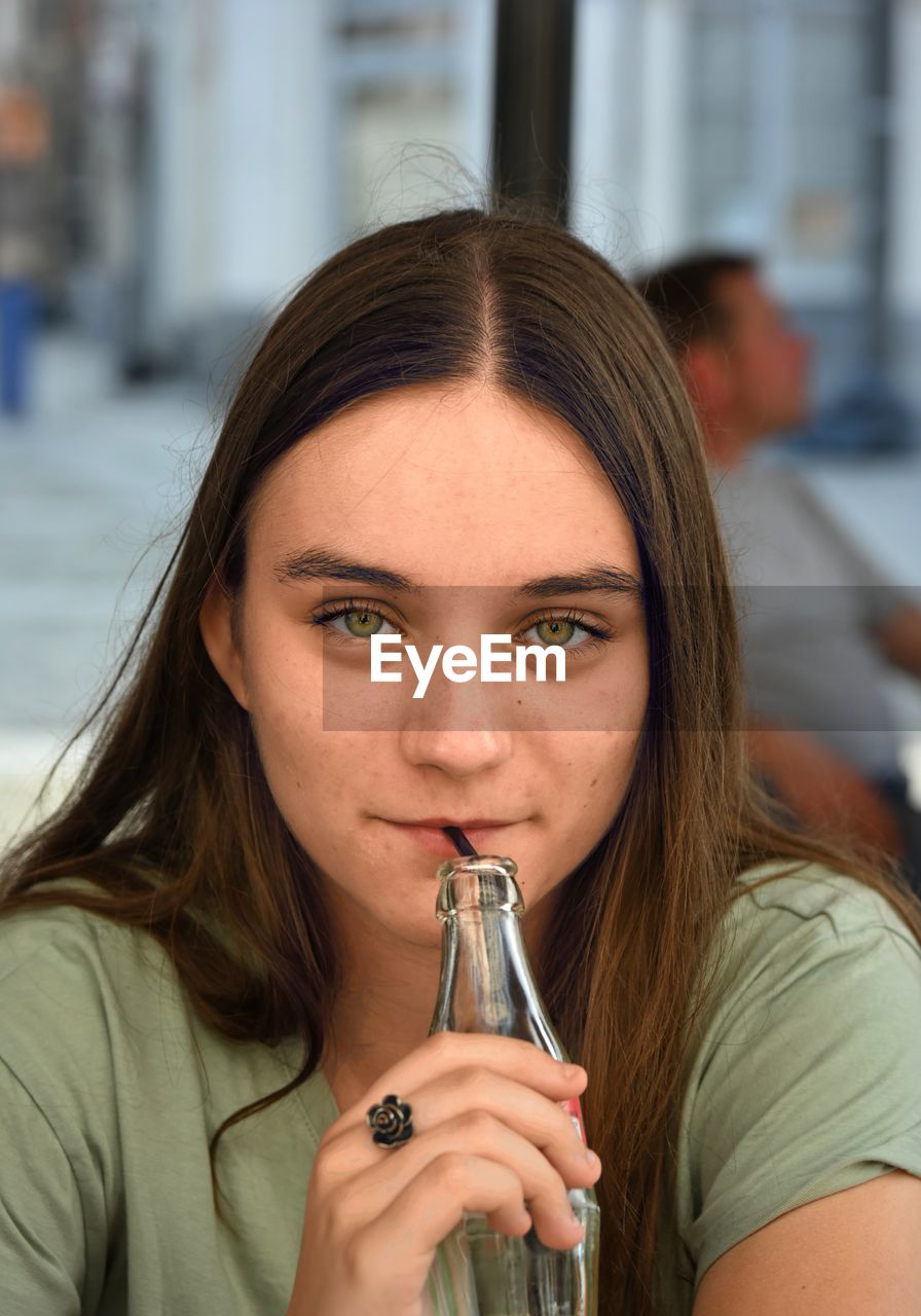Close-up of young woman drinking glass