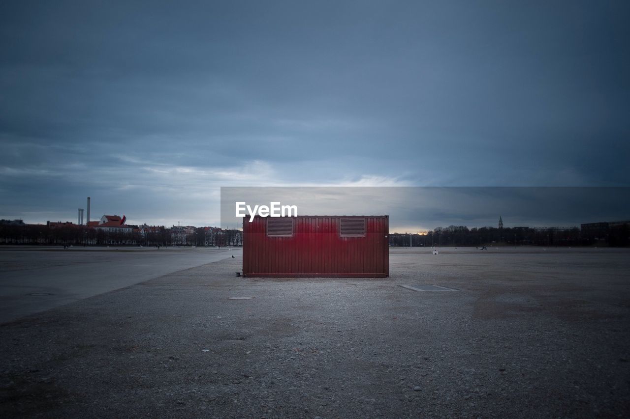 Abandoned structure against cloudy sky