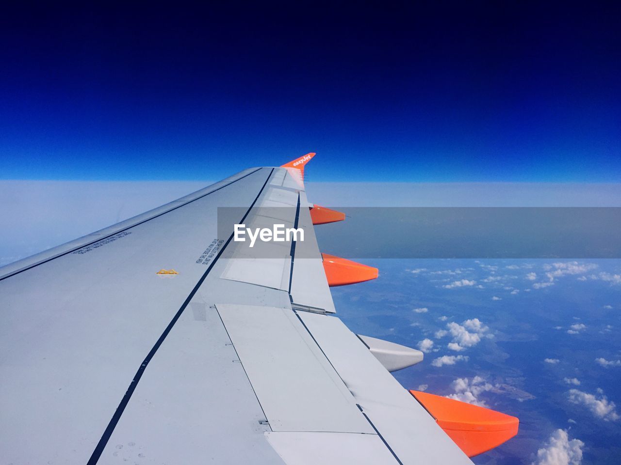 AIRPLANE WING OVER BLUE SKY