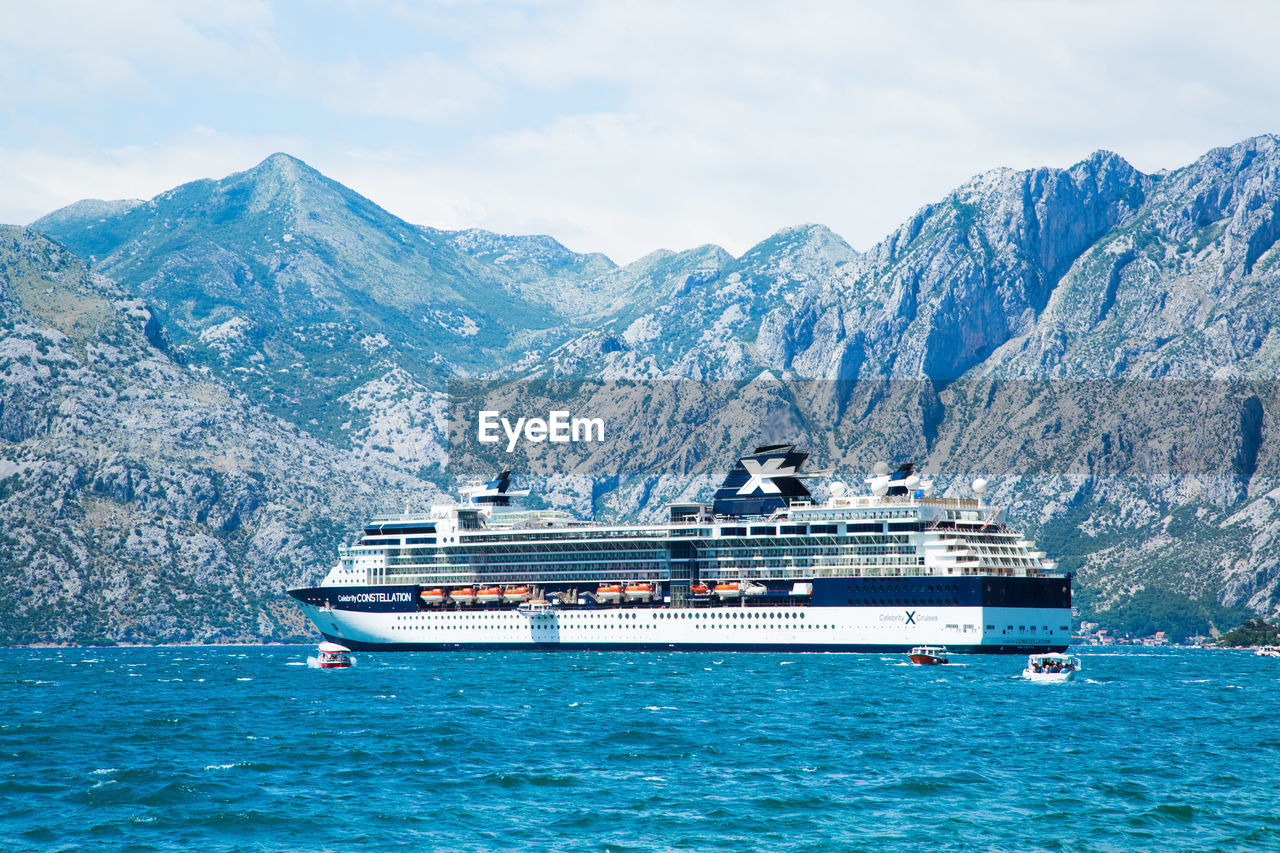 NAUTICAL VESSEL ON SEA AGAINST SNOWCAPPED MOUNTAINS