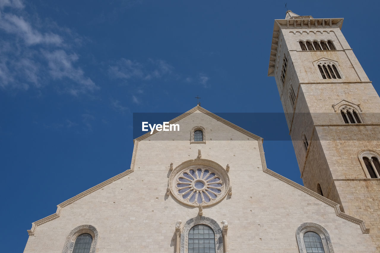 Low angle view of historic church and tower against sky