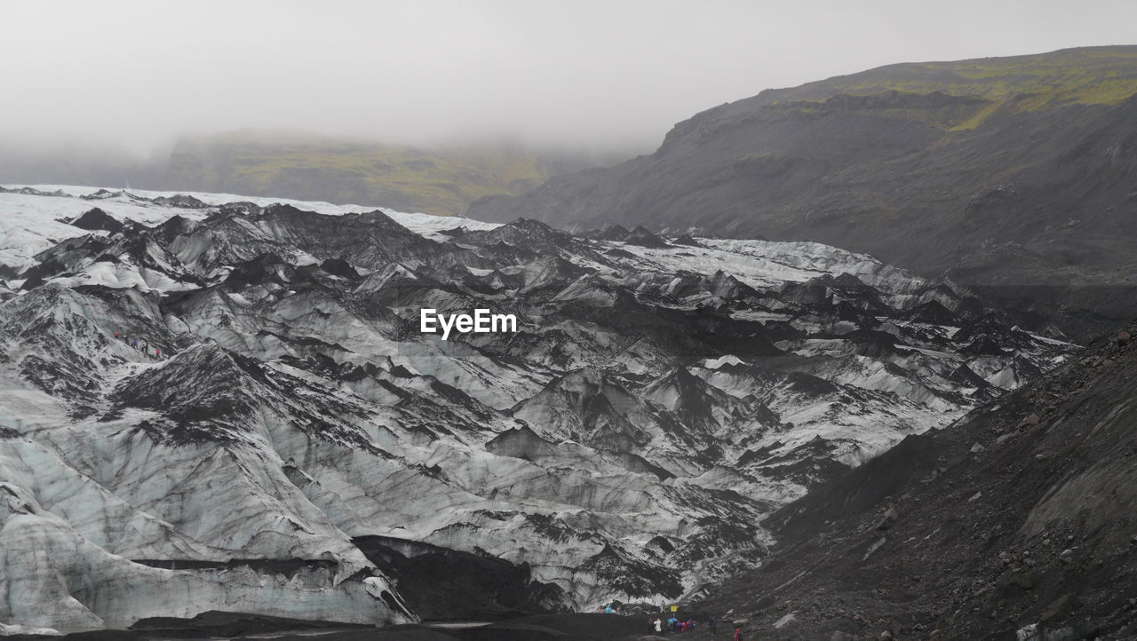 Scenic view of mountains against sky during winter