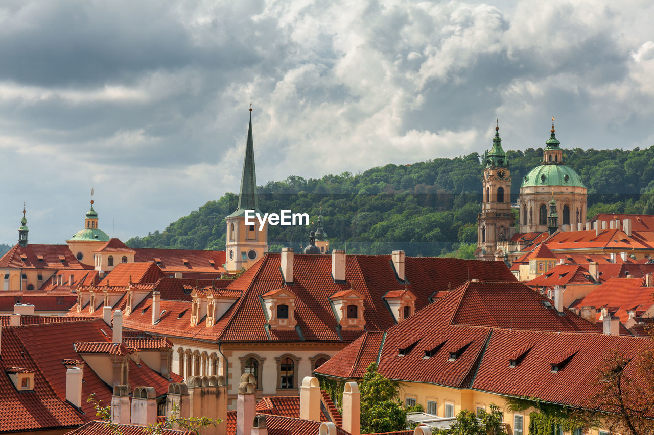 Lesser town rooftops and buildings with storm clouds on sky. the medieval settlement of prague.