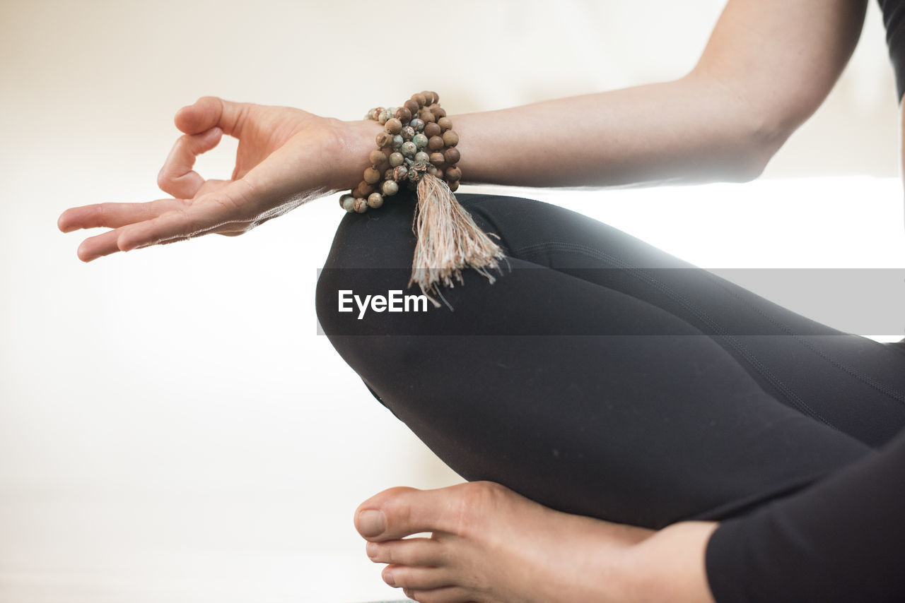 A girls hand in mudra during meditation.