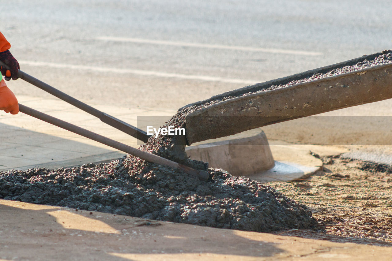 CLOSE-UP OF PERSON WORKING ON METAL SURFACE