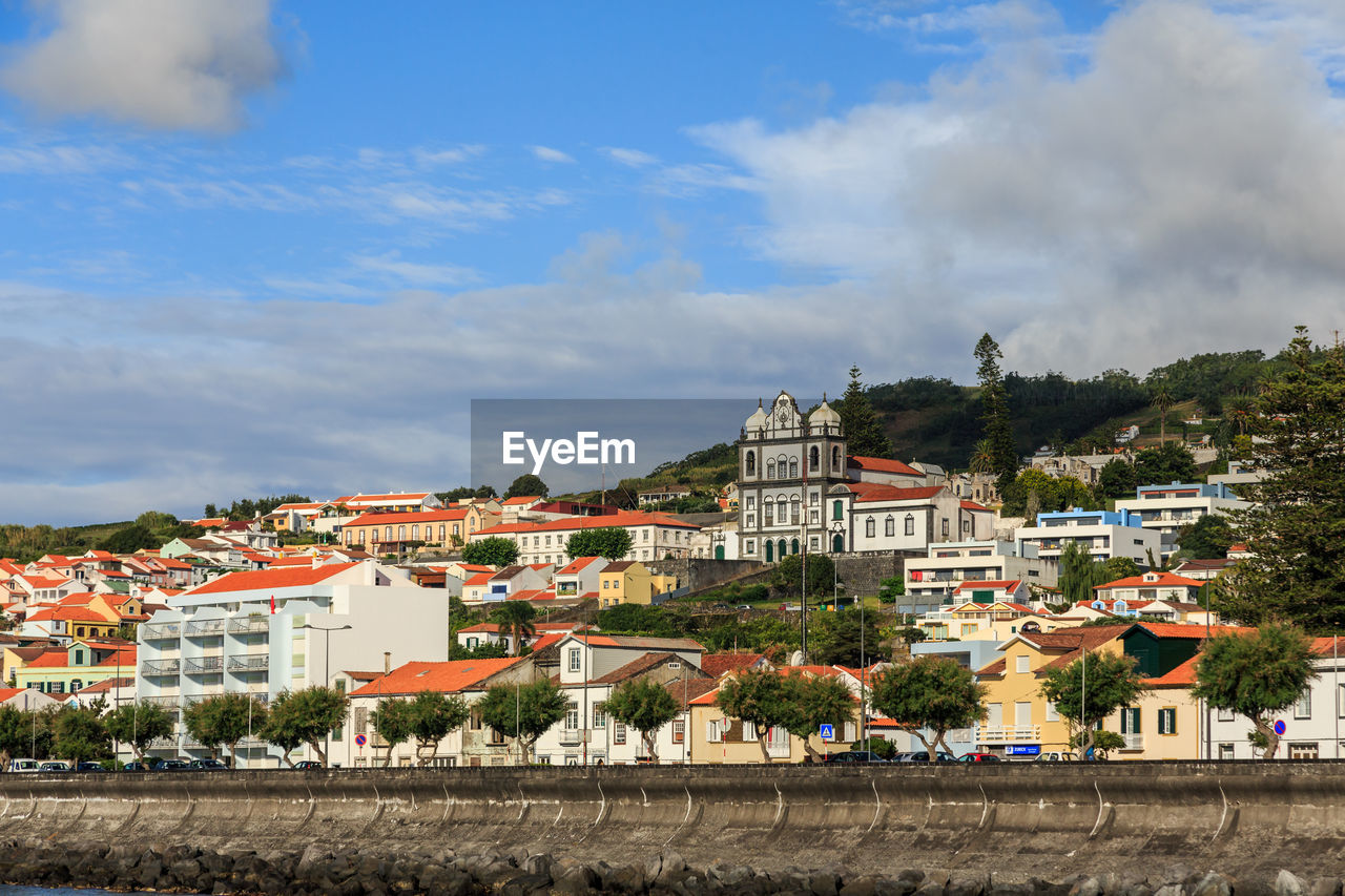 Buildings in town against sky