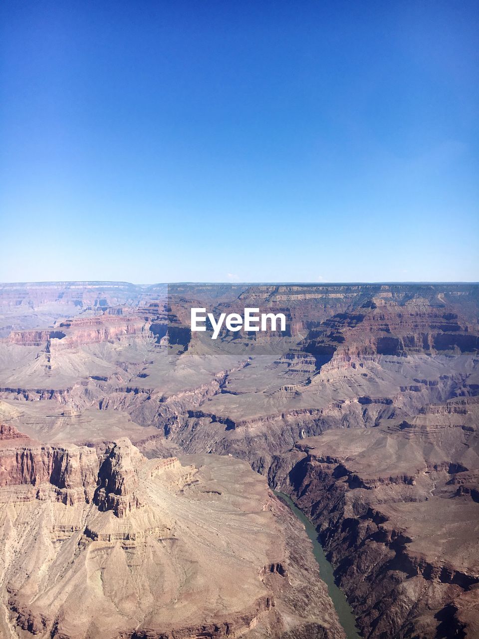 Scenic view of rock formations against clear blue sky