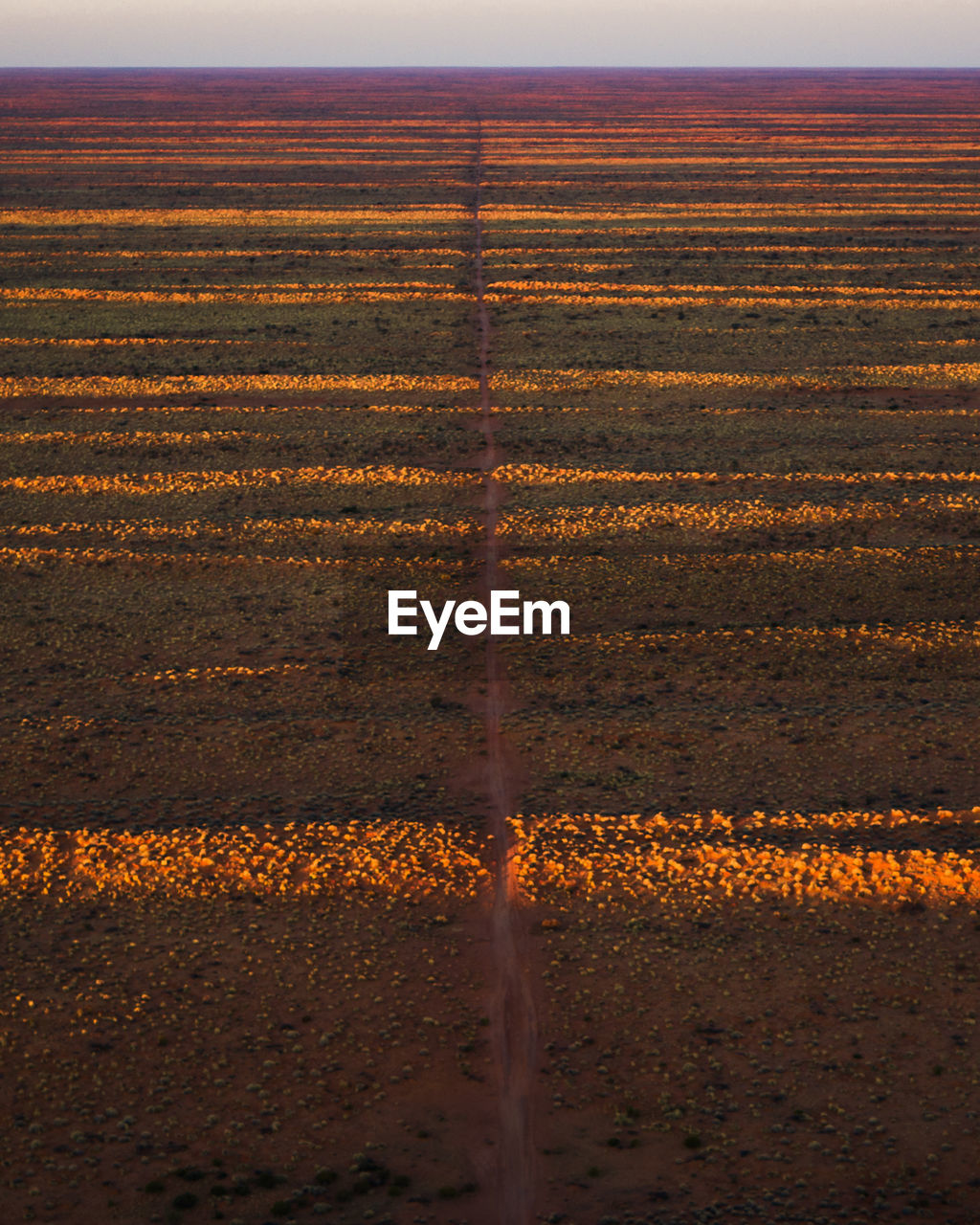 Scenic view of land on road against sky