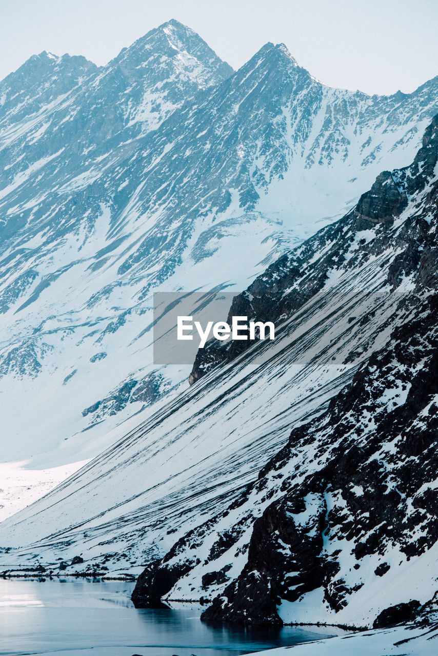 Snow-capped peaks tower over a pristine lake