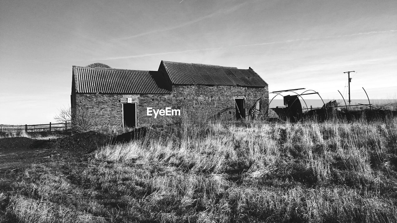 Built structure on landscape against the sky