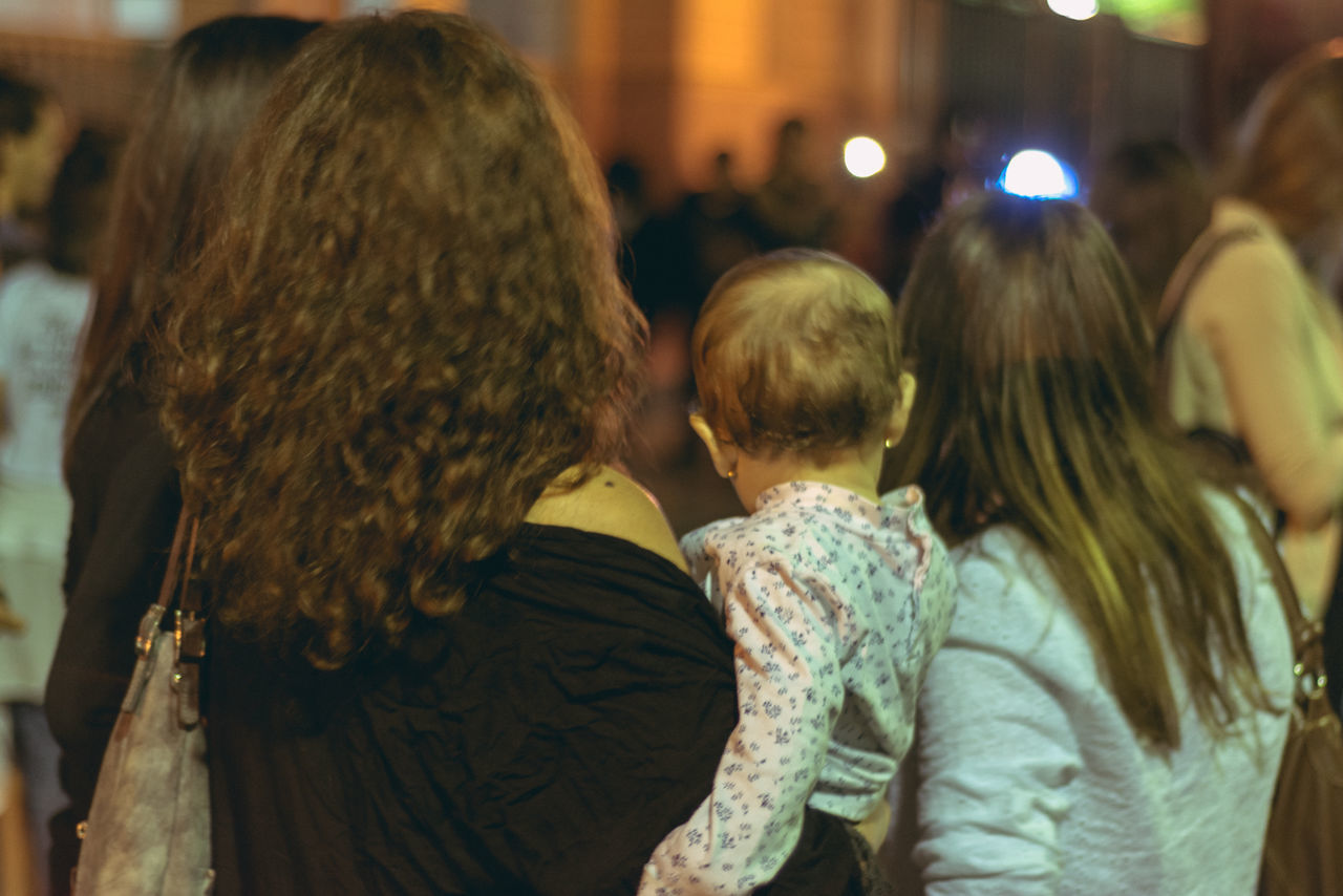 REAR VIEW OF PEOPLE AT ILLUMINATED STREET