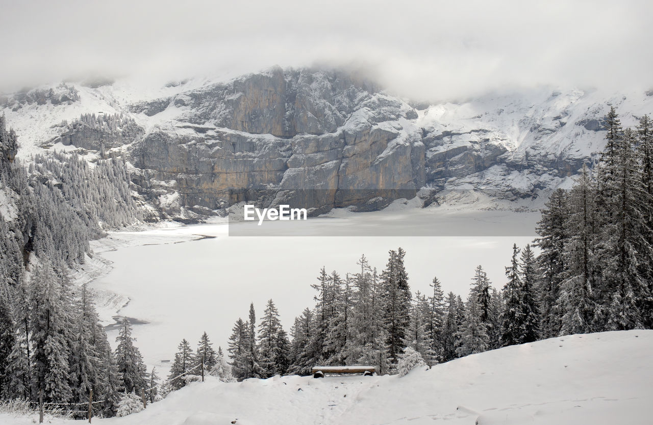 Panoramic winter landscape with frozen lake oeschinen and snow covered mountains, kandersteg