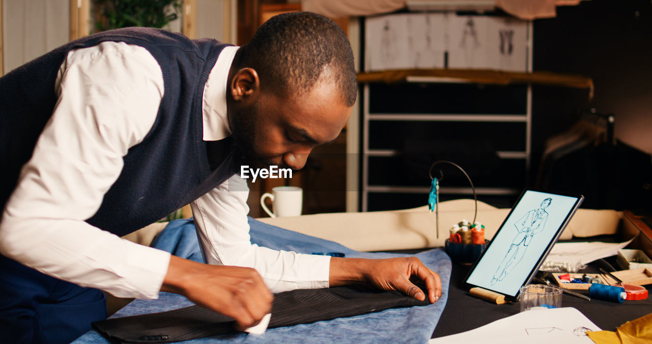 side view of man working at table