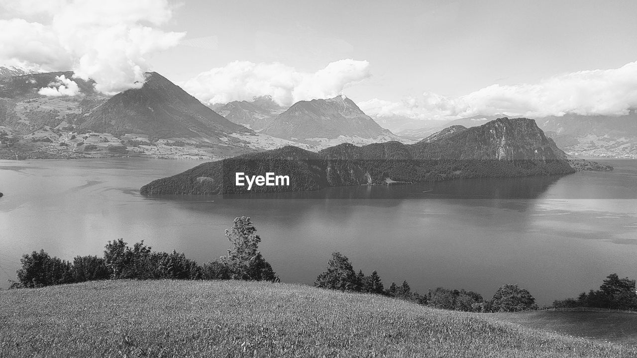 Scenic view of lake and mountains against sky