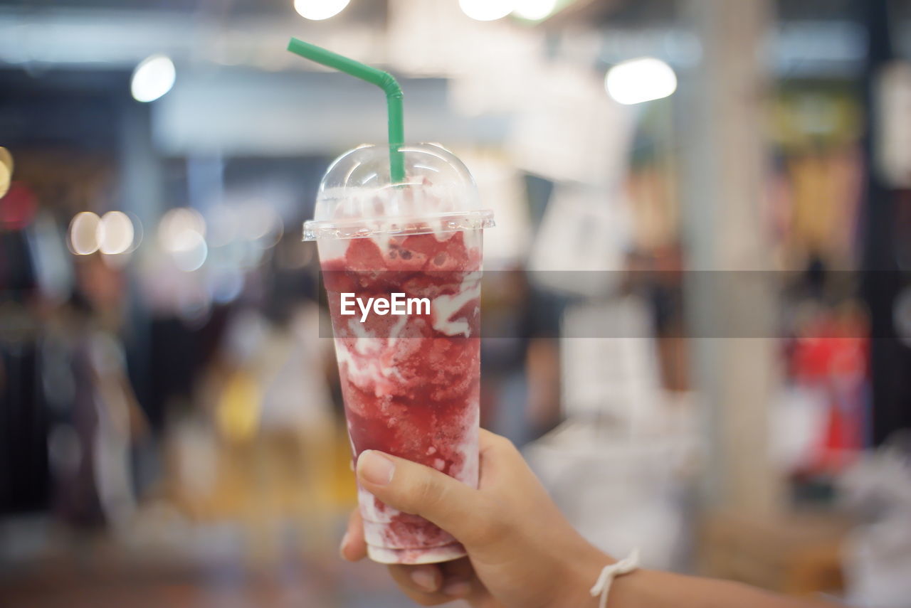 Close-up of hand holding glass of drink