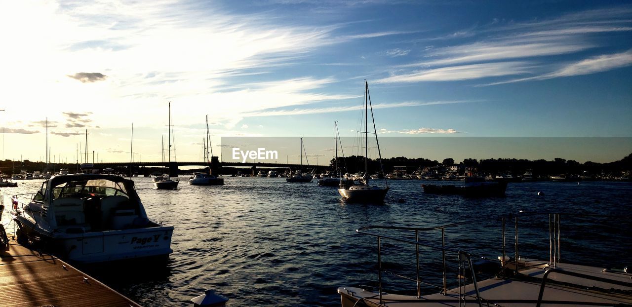 SAILBOATS MOORED AT HARBOR