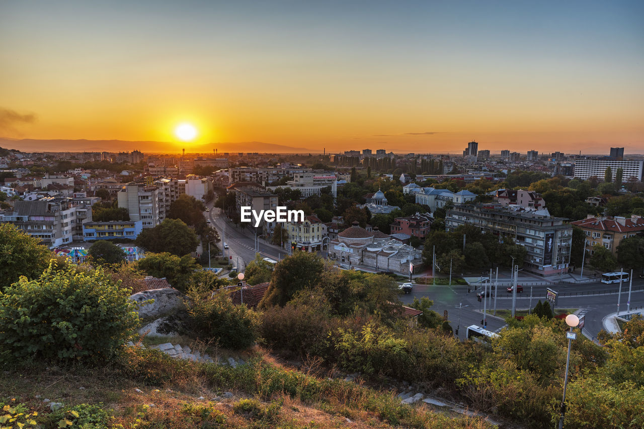 High angle view of buildings against sky during sunset