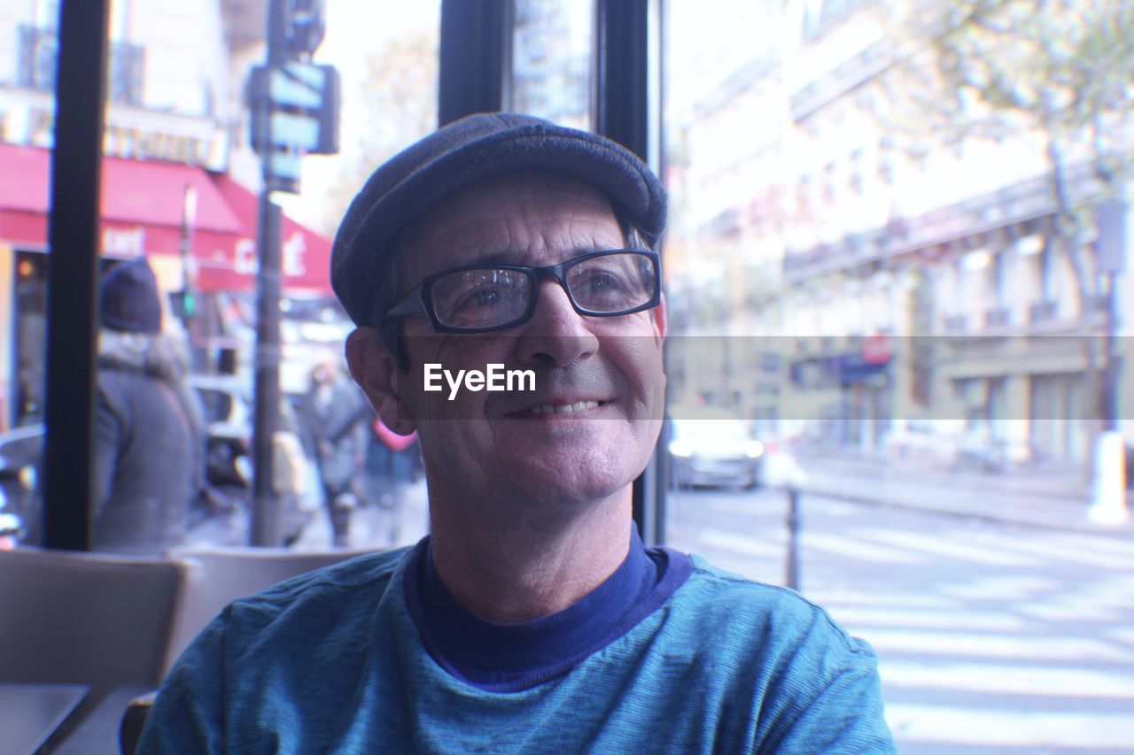 Smiling mature man looking away in city